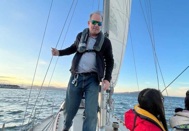 CFO elias of botrista poses on sail boat