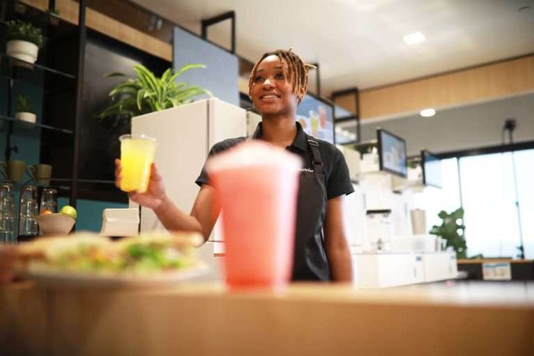 server hands mocktail to consumer during dry january