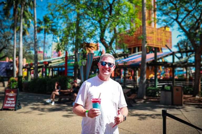 theme park guest poses with boba drink